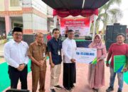 Soft Opening Pasar Modern Sorek, Bupati H.Zukri Serahkan Santunan JKM Kepada Ahli Waris Sudirman