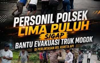 Aksi Sigap Personel Polsek Lima Puluh Evakuasi Truk Mogok di Perlintasan Rel Kereta Api