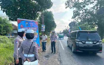 Personel Satlantas Polres Jember pasang banner imbauan di titik blackspot Desa Langkap Bangsalsari.